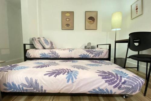 a bedroom with two beds with blue and white sheets at Heart of Miami sleeps 10 near Little Havana Beaches in Miami