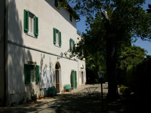 CollemezzanoにあるCase Vacanze Odifrediの緑の襖と木のある白い建物