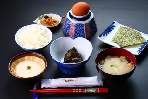 a group of bowls of food on a table at Dainichiya-ryokan in Sasaguri