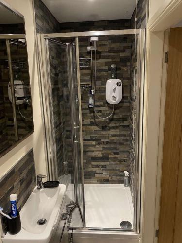 a bathroom with a shower and a tub and a sink at Lakeside Guesthouse Suite in Waddington