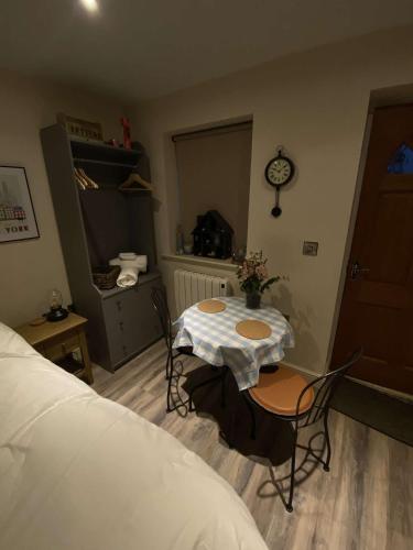 a room with a table and chairs and a bed at Lakeside Guesthouse Suite in Waddington