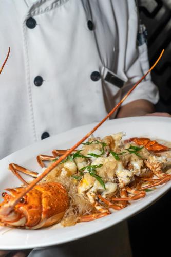 a plate of food with a lobster on a plate at Shenzhen Nanshan L'Hermitage in Shenzhen