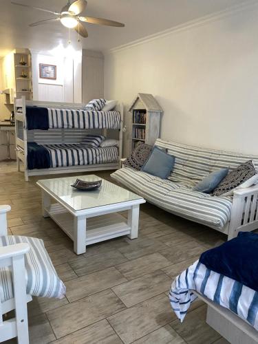 a living room with two couches and a coffee table at Flip-Flops in Jeffreys Bay