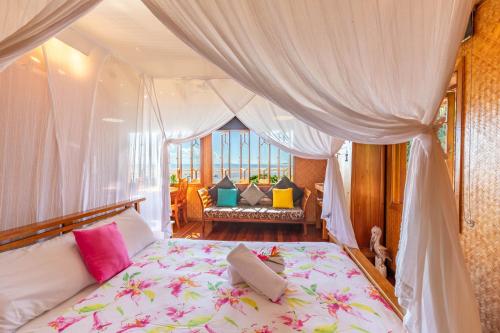a bedroom with a bed with a canopy at 1770 Beach Shacks in Seventeen Seventy