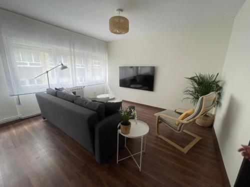 a living room with a couch and a table at BegoÑa Suite in Gijón