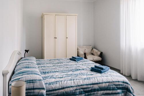 a bedroom with a bed and a white cabinet at Il Lampin B&B in Marina di Andora