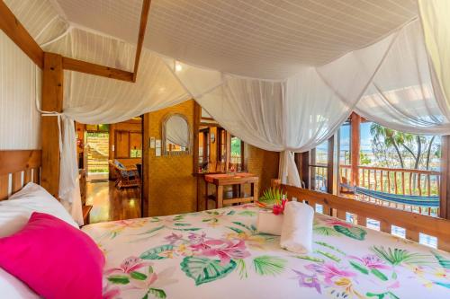 a bedroom with a bed with flowers on it at 1770 Beach Shacks in Seventeen Seventy
