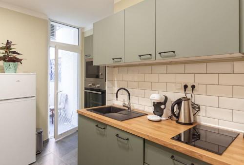 a kitchen with a sink and a counter top at Vysoká Apartman EMF/STP in Bratislava