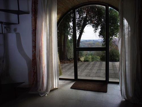 an open door with a view of a patio at Polvereto in Le Fornacette