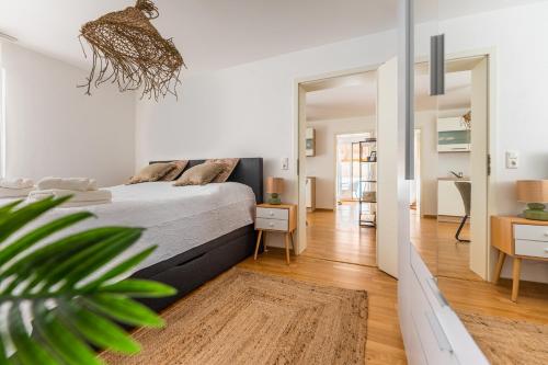 a bedroom with a bed and a living room at revLIVING Forest Hill Residence Krems-Stein inklusive Parkplatz in Krems an der Donau
