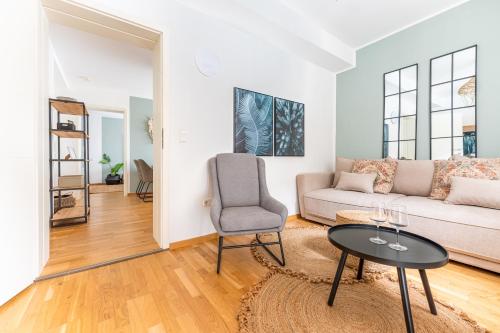 a living room with a couch and a table at revLIVING Forest Hill Residence Krems-Stein inklusive Parkplatz in Krems an der Donau