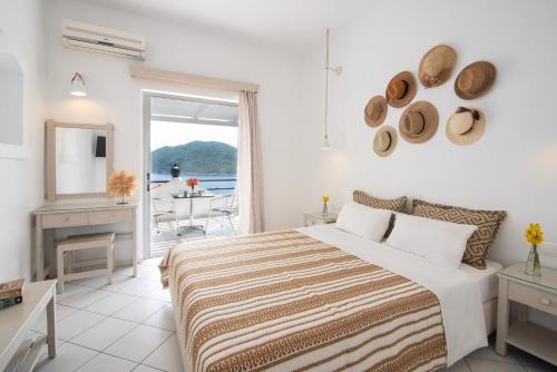 a bedroom with a bed and a view of the ocean at Nafsika Villas in Kerveli