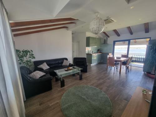 a living room with a couch and a table at Apartments Faust in Prvić Šepurine