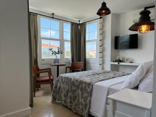 a hotel room with a bed and a window at Alacati Moonbox Hotel in Alacati