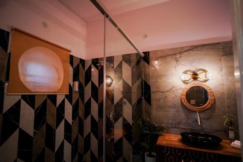 a bathroom with a shower and a mirror on the wall at Woodlands Cottage - Luxury stay in Jodhpur