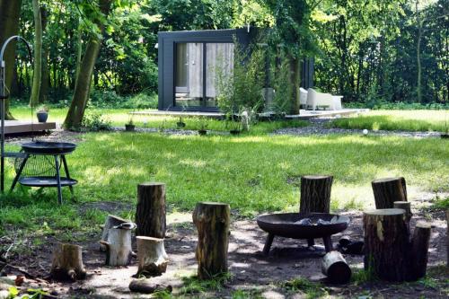 a garden with a table and a grill and trees at Domki Hrabiego- domek nr 2 in Rozkochów