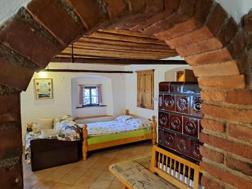 een slaapkamer met een bed en een bakstenen muur bij Apartment Zatrnik in Bled