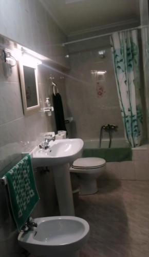 a bathroom with a sink and a toilet and a sink at Somonte Costa in Santander