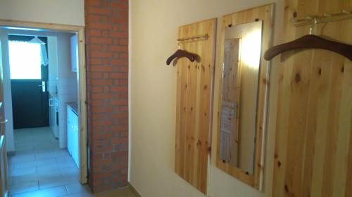 a room with wooden doors and a brick wall at Gartenblick in Brotterode-Trusetal