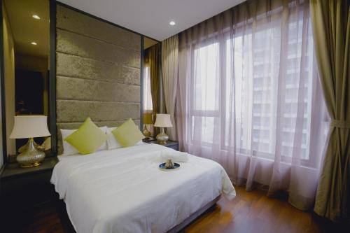 Un dormitorio con una gran cama blanca y una ventana en 8 KIA Peng, en Kuala Lumpur