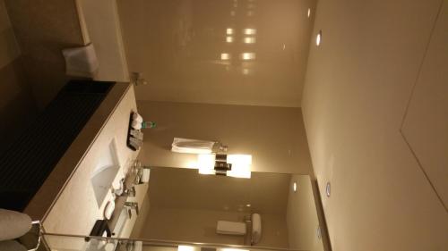 a bathroom with a sink and a mirror in a room at Somerset Greenways Chennai in Chennai