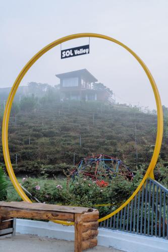 a large hula hoop with a bench and a roller coaster at Sol Valley - Hideaway Station in Blao Srê