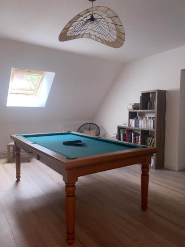 a pool table in a living room with at Les chambres de Christelle & Gilbert in Margon
