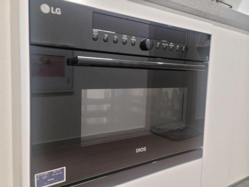 a microwave oven sitting inside of a kitchen at Harington Gwangan in Busan