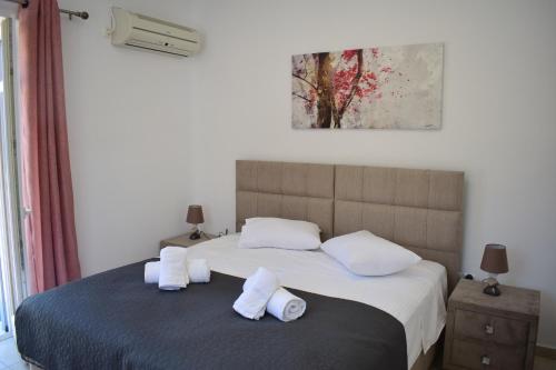 a bedroom with a large bed with white pillows at Lovely View in Kampos Paros