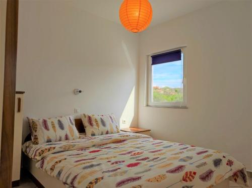 a bedroom with a bed and a window at Apartment Rose in Krk