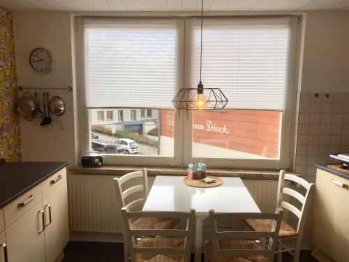 a kitchen with a table and chairs and a window at Ferienhaeuschen-Duderstadt in Duderstadt