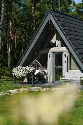 a small house with a bench and a table at Nordicstay Noarootsi Saunahouse in Paslepa