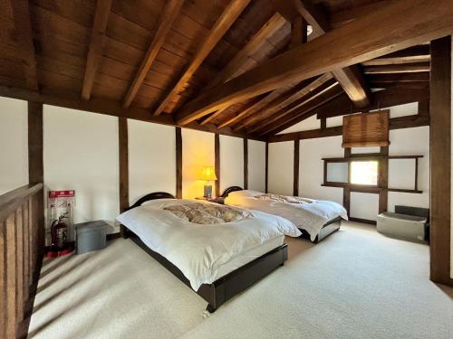 Postel nebo postele na pokoji v ubytování Guest House Shimoze Agematsu