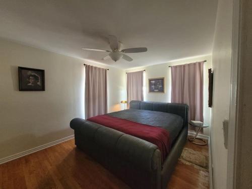 a bedroom with a bed and a ceiling fan at Moon Lakeview Apt at Crescent Lk in St Petersburg