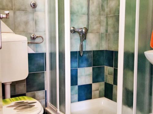 a bathroom with a shower with a toilet and a sink at Apartment Rose in Krk