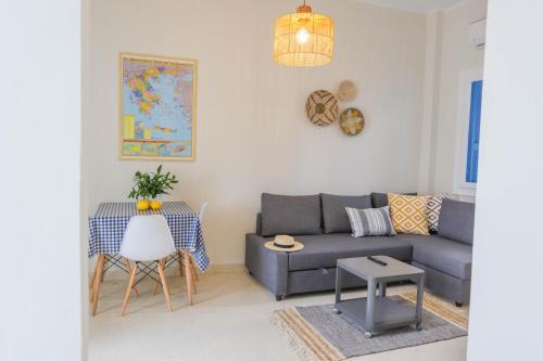 a living room with a couch and a table at Traditional Town Garden Apartment in Rhodes Town