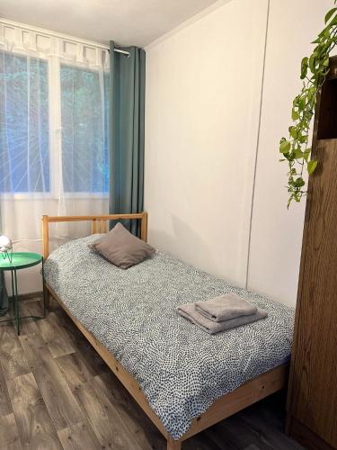a bedroom with a bed and a window at Olívia Vendégház Orfű in Orfű
