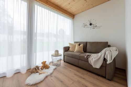 a living room with a couch and a window at Ländleapartments in Höchst