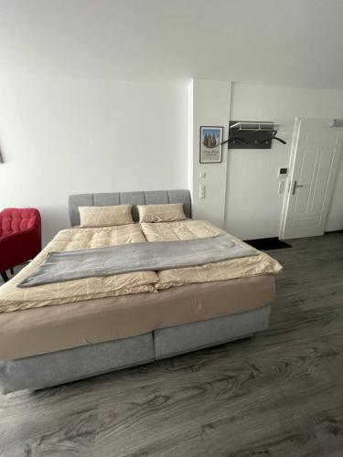 a bedroom with a large bed in a white room at SWID Appartement in Delitzsch