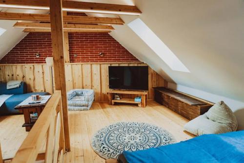 a living room with a blue couch and a tv at Podklášterský domek in Třebíč