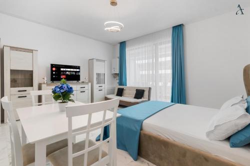 a bedroom with a bed and a table and chairs at RentForComfort Saint George Studio & Sea View in Mamaia