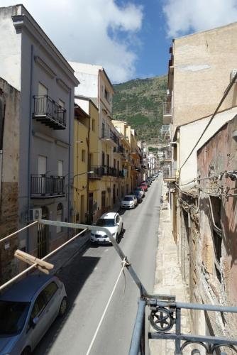 a street with cars parked on the side of the road at La Luna in Castellammare del Golfo