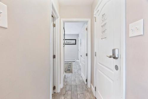 a hallway with a white door and a hallway with a floor at 33rd Unit 2 Catch some rays Parking Beach 2 Blocks Away in Brigantine