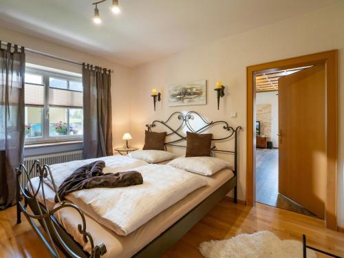 a bedroom with a large bed with a wrought iron headboard at Ferienwohnung Luna in Wörgl