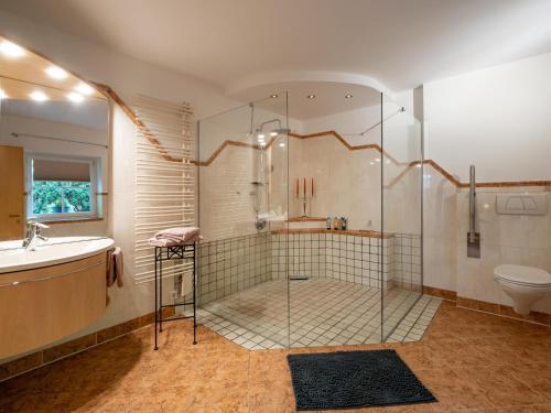 a bathroom with a shower and a sink and a toilet at Ferienwohnung Luna in Wörgl