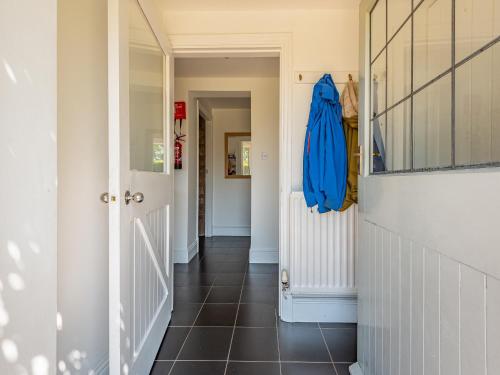 a hallway with a door and a tile floor at Haytongate Barn in Walton