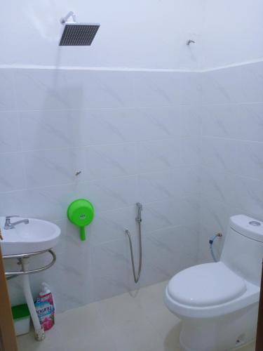 a bathroom with a toilet and a sink at CozyL Homestay in 3 minutes drive to Redang Jetty in Kampong Ru Sepuloh