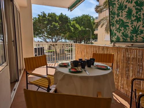 a table on a balcony with a table and chairs at Terraza con vistas al mar Parking privado 120 mts, junto a la playa in Cullera