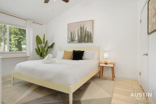 a white bedroom with a bed and a window at Stylish Austin Retreat w Luxurious King Bed and WD in Austin