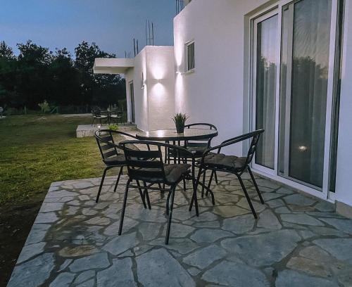 a patio with a table and chairs on a patio at Apartmani Živanović Ulcinj in Ulcinj